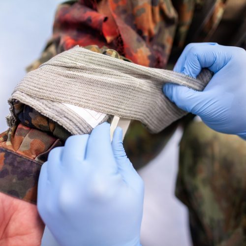 Paramedic soldier creates a bandage on a make up fracture
