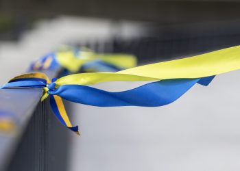 Ribbons in the colors of the national flag of Ukraine are tied to the handrail. Yellow-blue tapes.